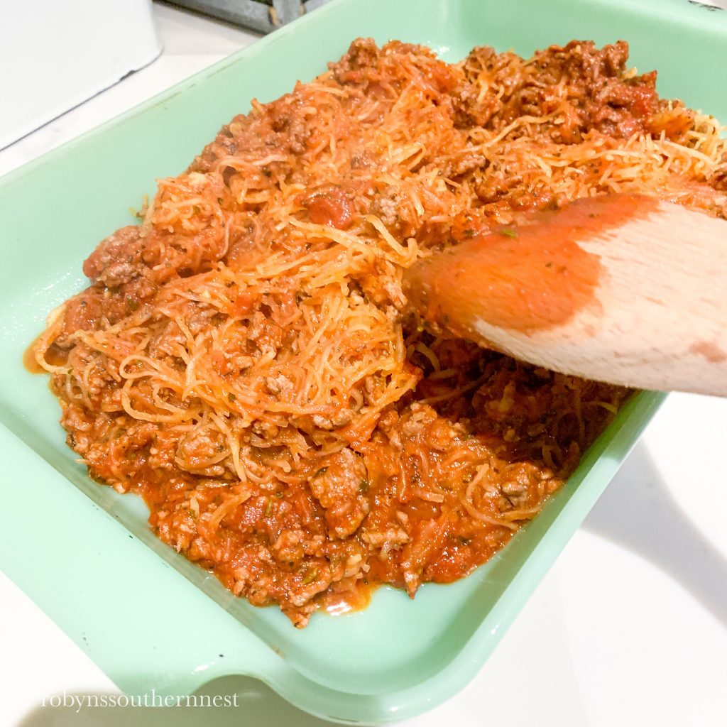 pour in your spaghetti squash and meat sauce into the baking dish 