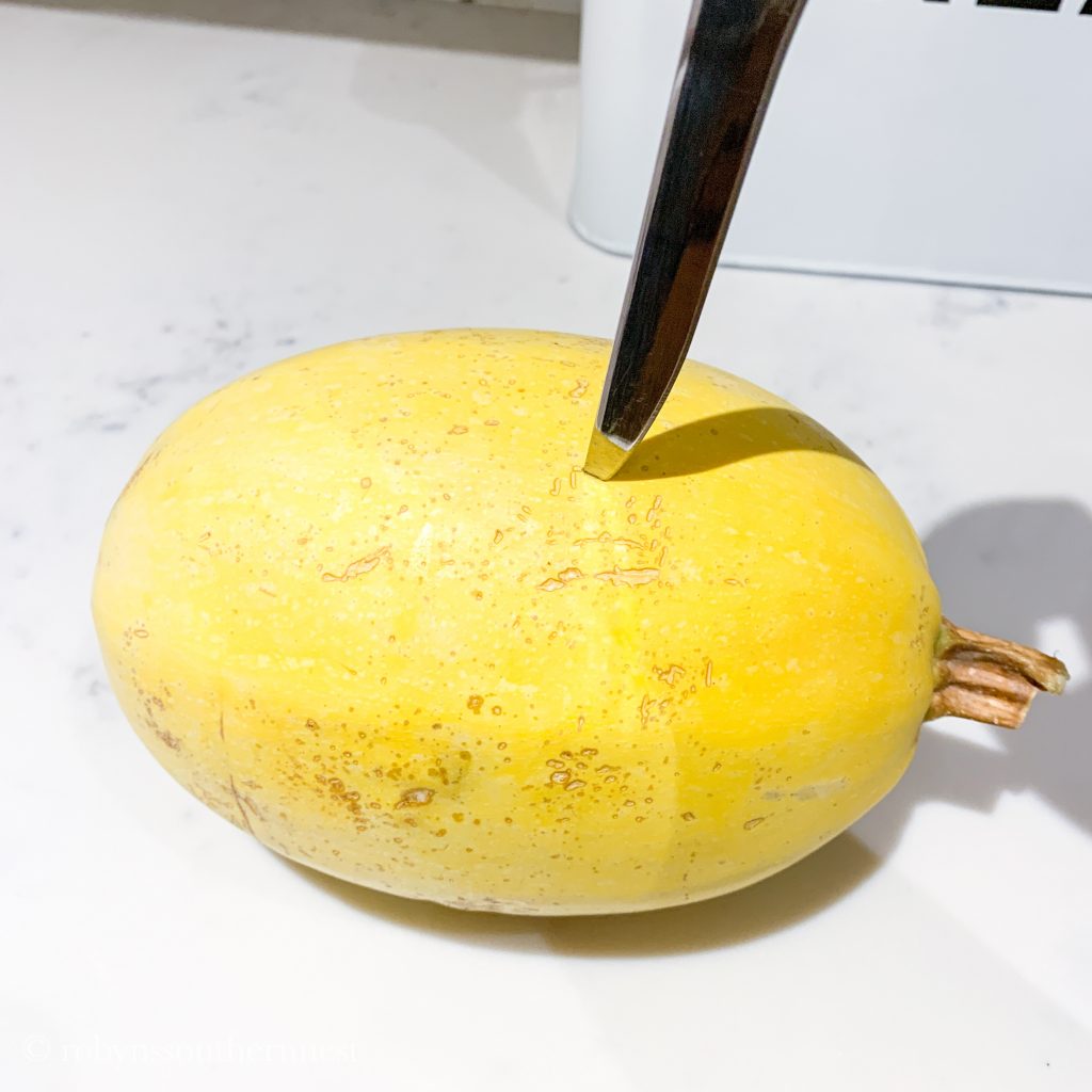 piericng the spaghetti squash with a knife- Robyn's Southern Nest