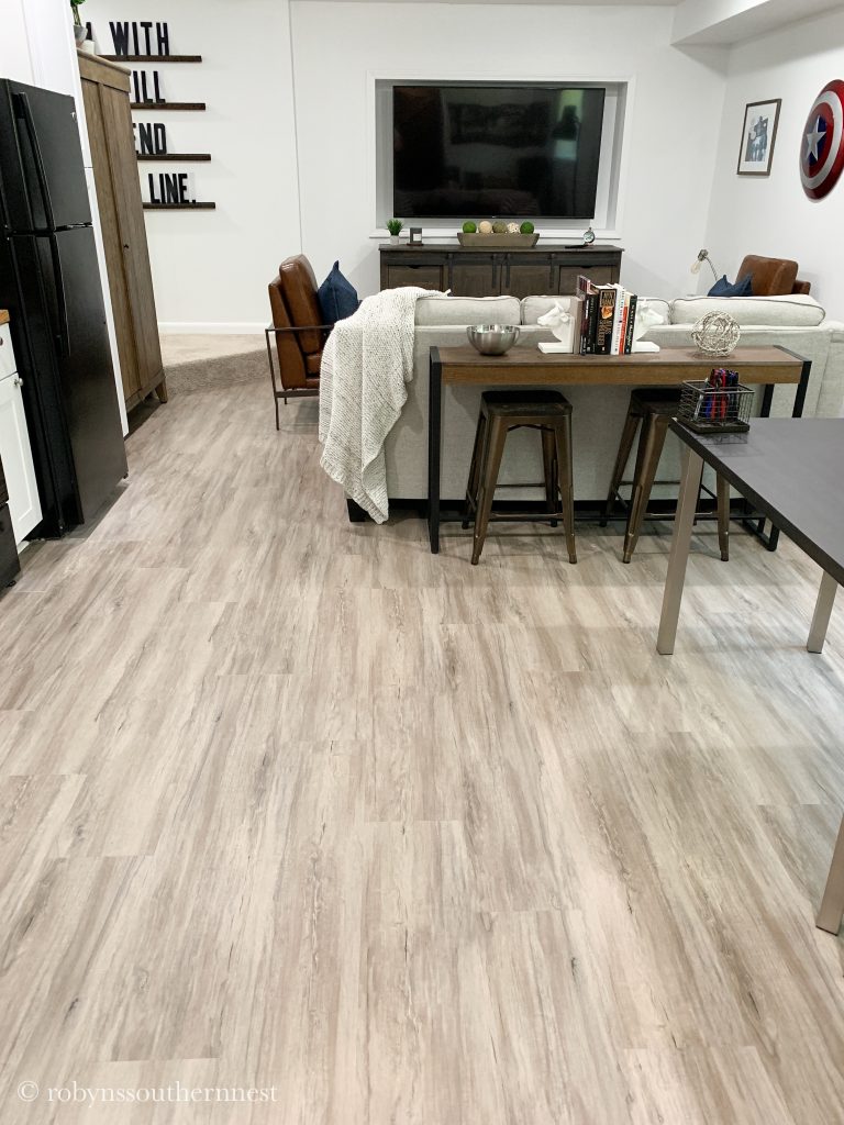 Basement Living room showing laminate flooring that looks like wood. 