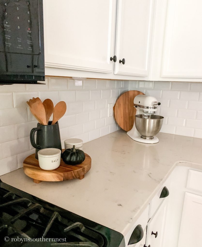 kitchen counter with tray of utensils and free standing mixer 