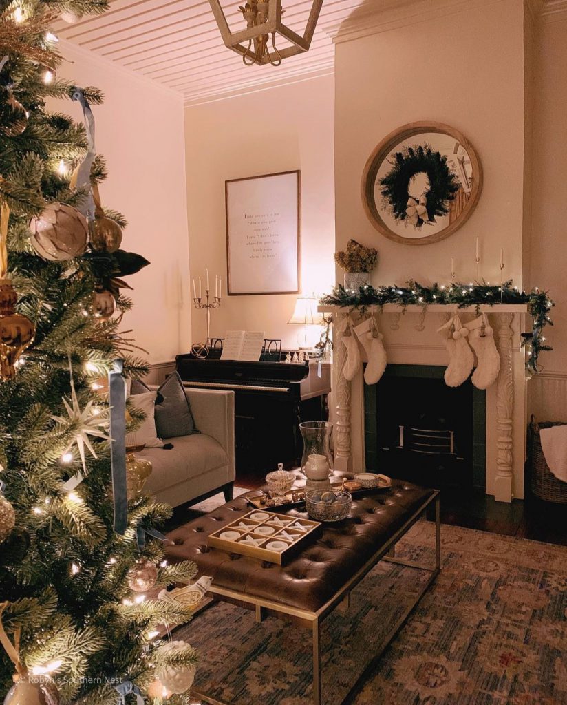 living room with mantel decorated with stockings and garland 